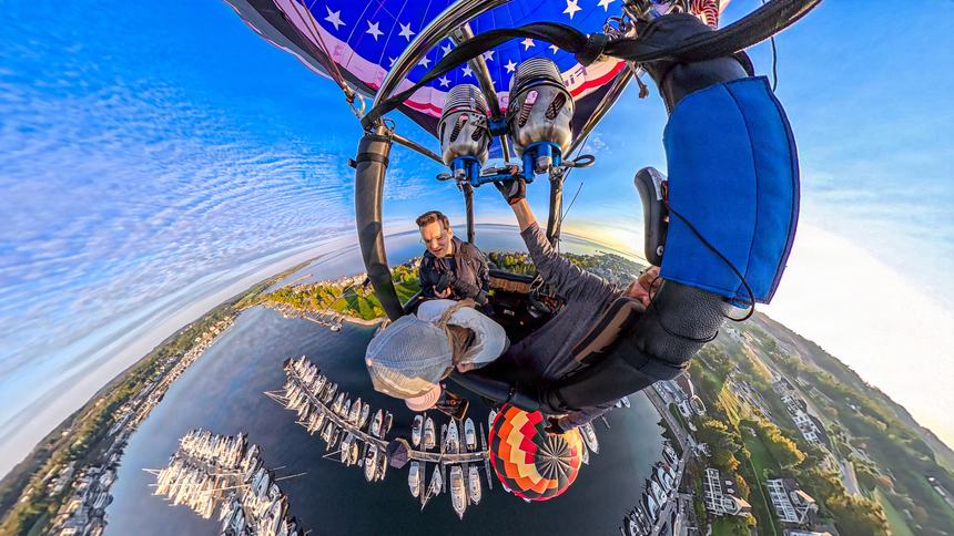 A 360-degree little-planet photograph from the balloon basket looking out along the curved horizon over Bay Harbor